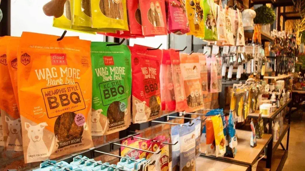 Wall of dog jerky and chew bags at Lola’s Corner pet store