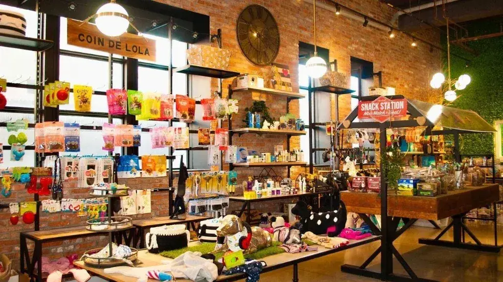 Wall of dog toys and apparel at Lola’s Corner pet store