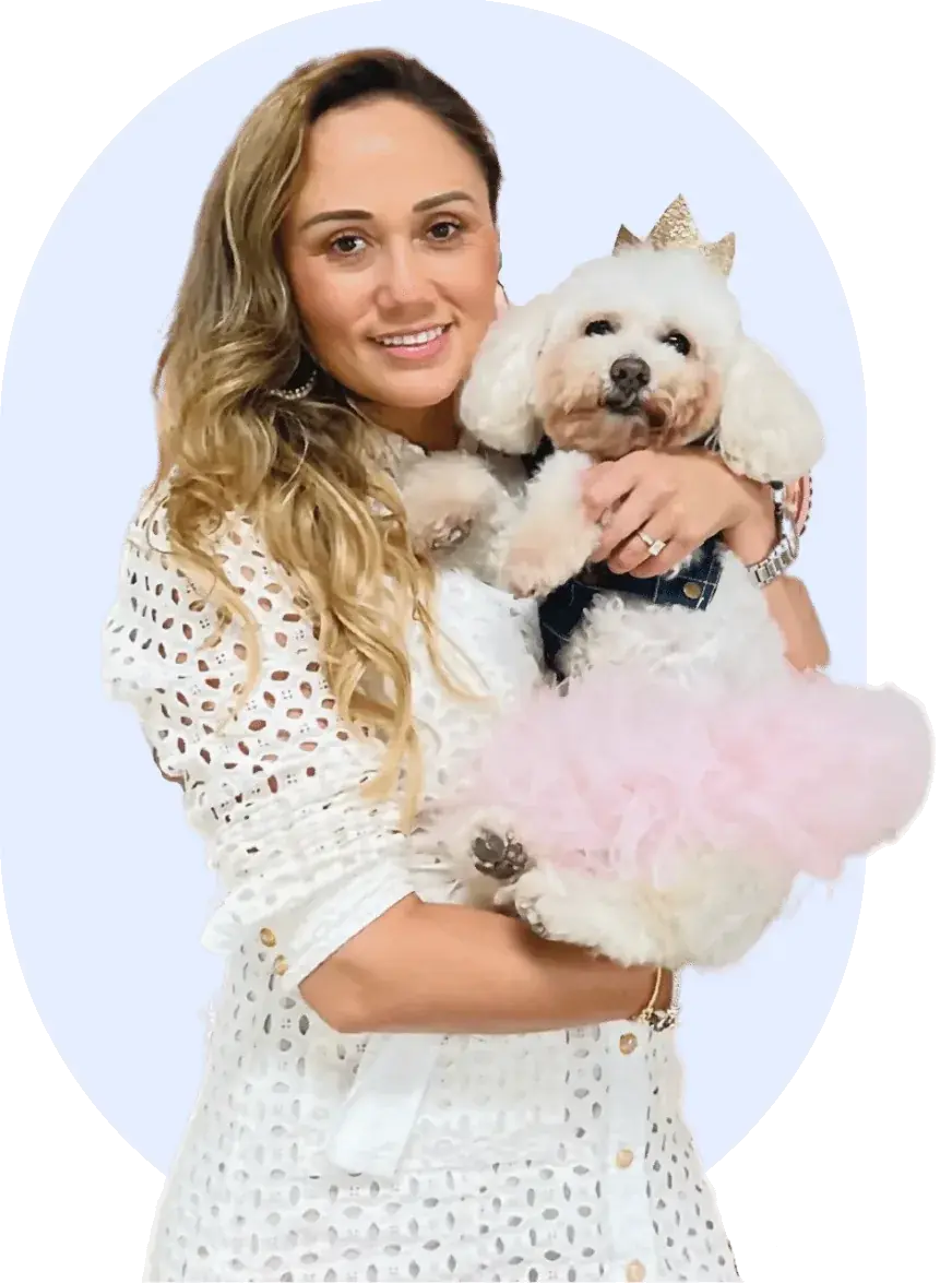 Pet parent holding a poodle wearing a tutu